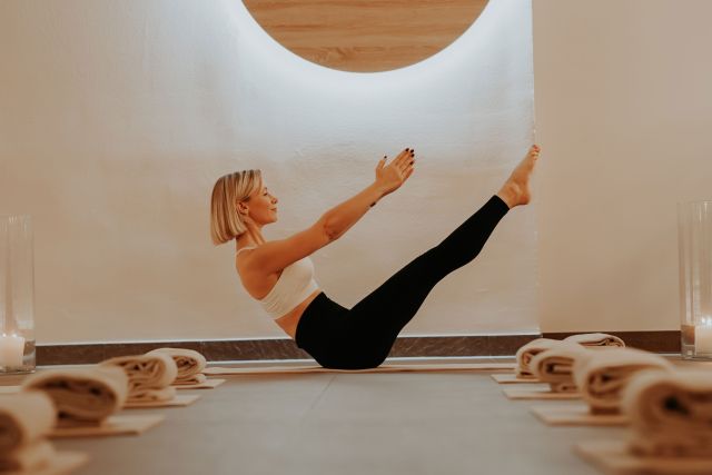 eine Frau macht Yoga in einem Fitnessstudio